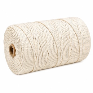 May include: A large spool of off-white twisted cotton cord wound tightly into a cylindrical shape. The cord features a multi-strand braided texture, and the spool has a visible brown cardboard core at the centre of the circular end.
