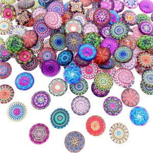 May include: Assortment of colourful round glass cabochons with intricate mandala designs. The cabochons are approximately 2.5 cm in diameter and feature a variety of colours, including red, blue, green, purple, and yellow.