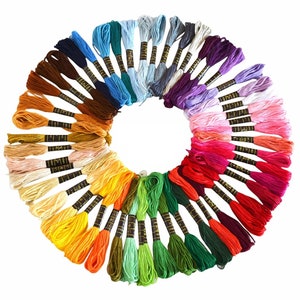 May include: A collection of 50 embroidery floss spools arranged in a circle, showcasing a rainbow of colours from red to purple, orange to green, and yellow to blue.