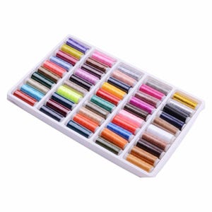 May include: A white plastic tray filled with 36 spools of colourful thread. The spools are arranged in rows and columns, and the colours are bright and varied.