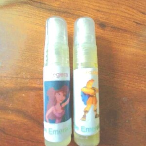 May include: Two clear plastic bottles with colourful labels featuring cartoon characters. The labels include the text "Empera" and "Empera".