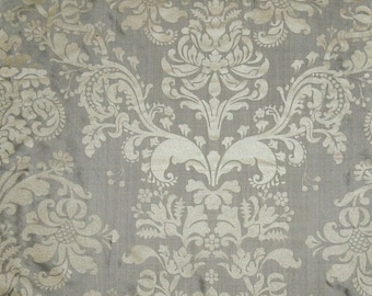 May include: A close-up of a fabric with a white damask pattern on a gray background.