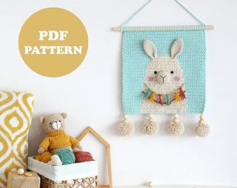 May include: A crochet wall hanging featuring a llama with a colorful tassel garland. The hanging is light blue with a white llama face and has wooden beads and pom-poms. The text "PDF PATTERN" is on a yellow circle.
