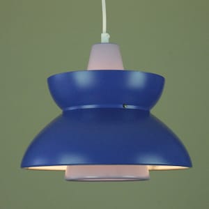 May include: A blue and white pendant light with a double-tiered shade. The top shade is a smaller, inverted cone shape, and the bottom shade is a larger, wider, bowl shape.
