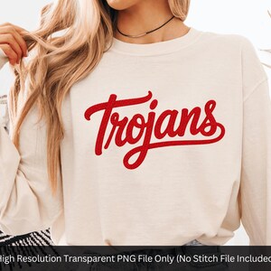 May include: Cream-colored sweatshirt with the word "Trojans" in red script across the chest. The long-sleeved top is made of a soft material. The text is in a cursive font.