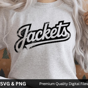May include: A light gray sweatshirt with the word "Jackets" in a distressed black font. The text is slightly curved and has a shadow effect. The sweatshirt is made of a soft material.