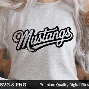 May include: A light gray sweatshirt with the word "Mustangs" in a black, distressed, cursive font. The text is outlined in white. The bottom of the image has the text "SVG & PNG" and "Premium Quality Digital Files".