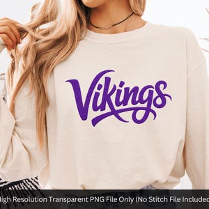 May include: Cream-colored sweatshirt with the word "Vikings" in purple script across the front. The long-sleeved top is made of a soft material. The image also includes the text "High Resolution Transparent PNG File Only (No Stitch File Included)".