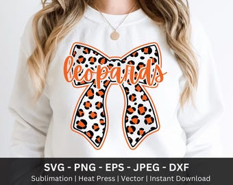 May include: White sweatshirt featuring a large bow design with a leopard print pattern in black and orange. The word "leopards" is written in orange script across the bow. Below the bow are the file types: SVG, PNG, EPS, JPEG, and DXF.
