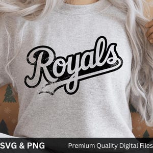 May include: A pale grey sweatshirt featuring the word "Royals" in black, distressed script. The image includes the text "SVG & PNG" and "Premium Quality Digital Files" at the bottom.