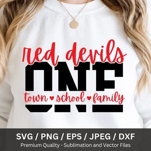 May include: White sweatshirt with the text "red devils ONE town school family" in red and black. The design includes hearts and is likely for a school or team. The bottom of the image shows file format options.