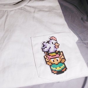 link holding a chicken pocket tee