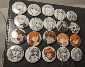 May include: A collection of 18 round, white button pins featuring black and white illustrations of anime characters. The pins are arranged in a grid pattern on a black surface.