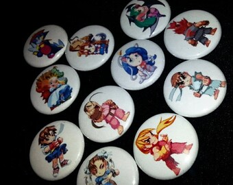 May include: Ten round, white button pins with colorful cartoon images of characters from the Street Fighter video game series.