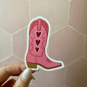 May include: Pink cowboy boot sticker with three red hearts and the text "XOXO" on the top.