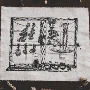 May include: Black and white illustration of a window with dried herbs hanging from a string. There are several glass jars on a shelf below the window.