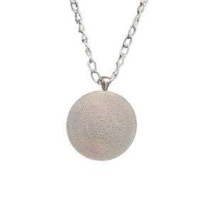 May include: Silver chain necklace with a round silver pendant. The pendant has a textured surface.