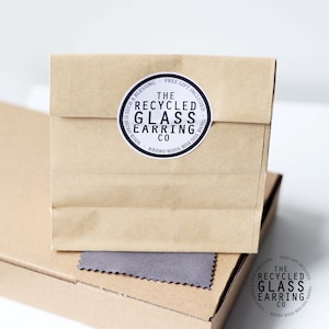 May include: A brown paper bag with a sticker that says "The Recycled Glass Earring Co." and "Your order is such a blessing - Free gift included - Thank you for your order."