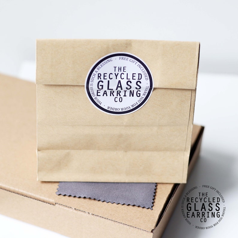 May include: A brown paper bag with a sticker that says "The Recycled Glass Earring Co." and "Your order is such a blessing - Free gift included - Thank you for your order."