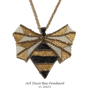 May include: A gold and black beaded bee pendant necklace with a geometric design. The pendant is shaped like a bee with wings and a body. The necklace is made of a gold chain.