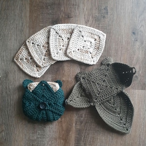 May include: Set of six crocheted square coasters in beige and brown tones, and two crocheted green dishcloths with a button.