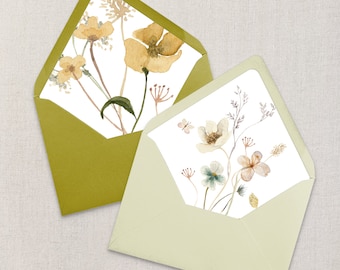 Puede incluir: Dos sobres con diseños florales. El sobre de la izquierda es verde con un diseño de acuarela de flores amarillas y hojas verdes. El sobre de la derecha es verde claro con un diseño de acuarela de flores blancas y rosas y hojas verdes.