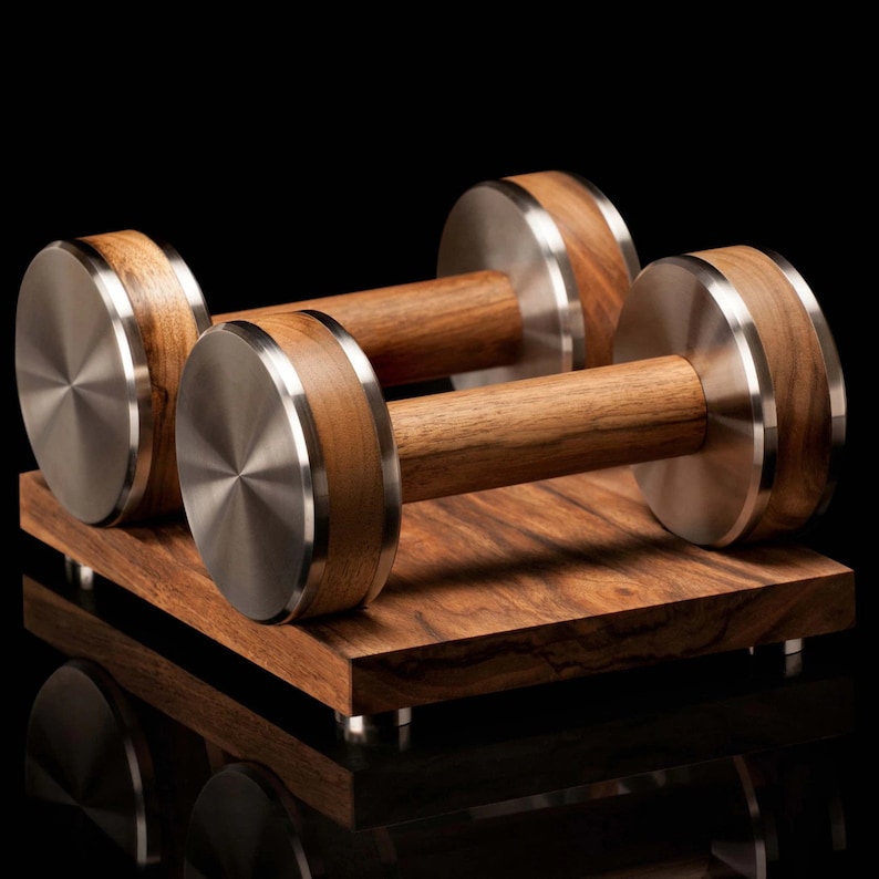 The Coretez dumbbell set, each weighing 6 kg, has smooth-textured wooden handles and stainless steel tips for an elegant look. They come with a matching wooden base for storage. Dumbbells add sophistication to any home gym.