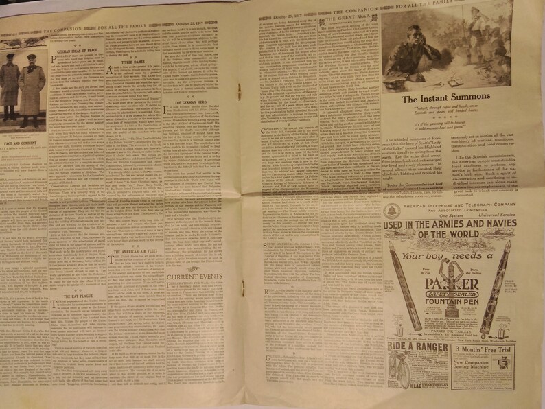May include: A black and white newspaper page with text and images. The text includes the words "The Instant Summons", "Current Events", and "Used in the Armies and Navies of the World". The images include a group of people in military uniforms, a man writing at a desk, and a Parker fountain pen.