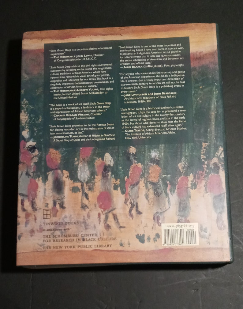 May include: The back cover of a book titled "Souls Grown Deep" with a quote from John Lewis, a member of Congress and cofounder of SNCC. The book is about the civil rights movement and the cultural traditions of Black America. The book is published by Tinwood Books in association with the Schomburg Center for Research in Black Culture, The New York Public Library.