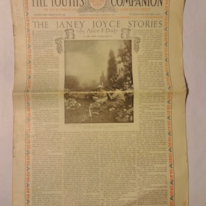 May include: A vintage magazine cover for The Youth's Companion, dated October 24, 1913. The cover features a black and white illustration of a young woman sitting in a field of tall grass, with a book in her lap. The magazine title is printed in bold, red letters.