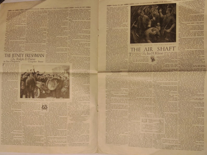 May include: A vintage newspaper page with two stories, "The Jitney Freshman" and "The Air Shaft". The Jitney Freshman story features a black and white illustration of a group of people gathered around a car. The Air Shaft story features a black and white illustration of miners working in a dark, underground mine.