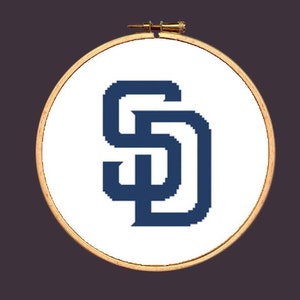 May include: A white embroidery hoop with a navy blue "SD" logo in the centre.