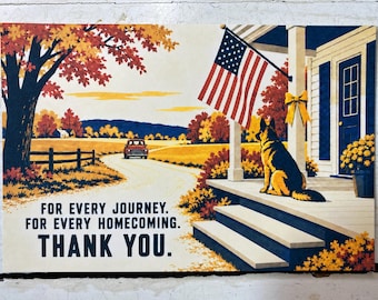 May include: A rectangular print featuring a German Shepherd sitting on a porch with an American flag, a yellow bow, and a red truck on a country road. The text reads: FOR EVERY JOURNEY. FOR EVERY HOMECOMING. THANK YOU. The scene has autumn foliage.