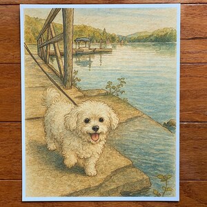 May include: A watercolor print depicting a small, fluffy white dog with a black nose and tongue out, walking on a wooden dock by a lake. The scene includes a wooden railing, calm blue water, distant green hills, and a small boat at a pier.
