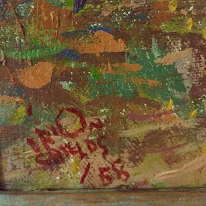 May include: Close-up of a red signature on a canvas with a textured, abstract background. The signature reads "LEON GREILDS 1955".
