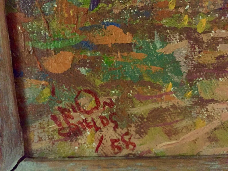 May include: Close-up of a red signature on a canvas with a textured, abstract background. The signature reads "LEON GREILDS 1955".