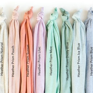 May include: A set of ten fabric swatches in various shades of heather grey, peach, coral, lilac, mint green, dusty blue, ice blue, and blue. The swatches are arranged in a row from left to right.