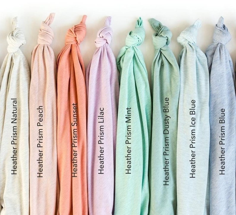 May include: A set of ten fabric swatches in various shades of heather grey, peach, coral, lilac, mint green, dusty blue, ice blue, and blue. The swatches are arranged in a row from left to right.