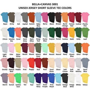 May include: A chart showing the color options for Bella + Canvas 3001 unisex jersey short sleeve t-shirts. The chart shows 60 different colors, including aqua, army, ash, asphalt, autumn, baby blue, berry, black, brown, burnt orange, canvas, cardinal, charity pink, citron, columbia blue, coral, dark grey, dark olive, deep teal, dusty blue, evergreen, forest, fuchsia, gold, kelly, leaf, light blue, lilac, maize yellow, maroon, mauve, military green, mint, mustard, natural, navy, ocean blue, olive, orange, orchid, oxblood black, pebble, pink, poppy, red, rust, sand dune, silver, soft cream, soft pink, solid athletic grey, steel blue, storm, sunset, synthetic green, tan, teal, team navy, team purple, true royal, turquoise, vintage black, vintage white, white, and yellow.