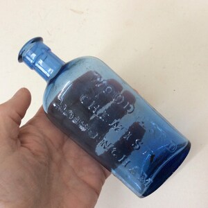 Antique Cobalt Blue Poison Bottle, Woodwards,Chemist,Nottingham.6 inches high. C1900-20. Nice air bubbles. CHIP to top lip. (G)