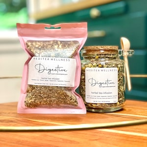 May include: A pink pouch and a glass jar of herbal tea, labeled "Digestive" by Meditea Wellness. The pouch contains 2.5 oz and the jar contains 3 oz of tea. A wooden spoon rests on the jar. The tea is for a balanced digestive system.
