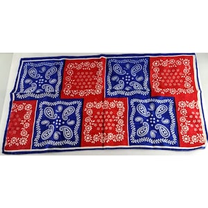 May include: A red, white, and blue bandana with a paisley pattern. The bandana is made of cotton and is perfect for adding a touch of style to any outfit.