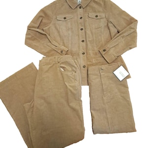 May include: A tan corduroy set consisting of a long-sleeved button-down shirt with two chest pockets and a pair of matching wide-leg trousers. The shirt features a classic collar and buttons down the front. A small white tag is attached to the trousers.