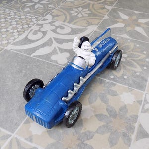 Cast Iron &quot; MICHELIN MAN In Blue Racing Car Hubley 1934 &quot; 10 inches long