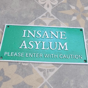 INSANE ASYLUM Please enter with Caution Cast Iron Sign 27cm x 13cm