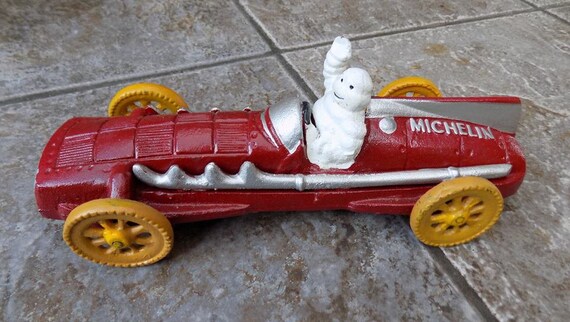 SUPERB HEAVY CAST IRON MICHELIN MAN BIBENDUM IN RED RACING CAR,HUBLEY 1934