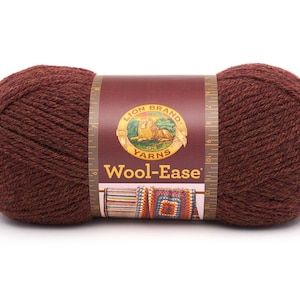 May include: A skein of Lion Brand Wool-Ease yarn in the color "Brown Heather". The yarn is a medium weight and is made of 100% acrylic. The skein is wrapped around a label with the Lion Brand logo and the yarn name.