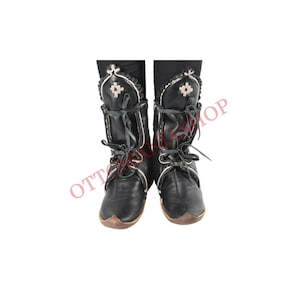 May include: A pair of black leather boots with white stitching and decorative details. The boots have laces and a pointed toe.