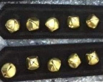 A pair of boot straps with bells on.