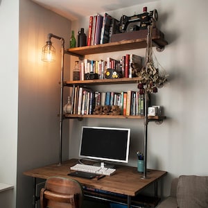 Industrial pipe desk with shelving unit and built-in lamp